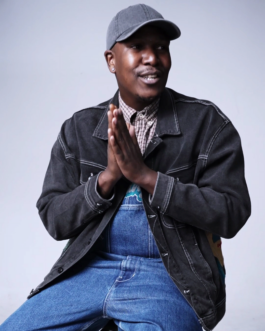 Lee Custom Series seated portrait in black denim jacket