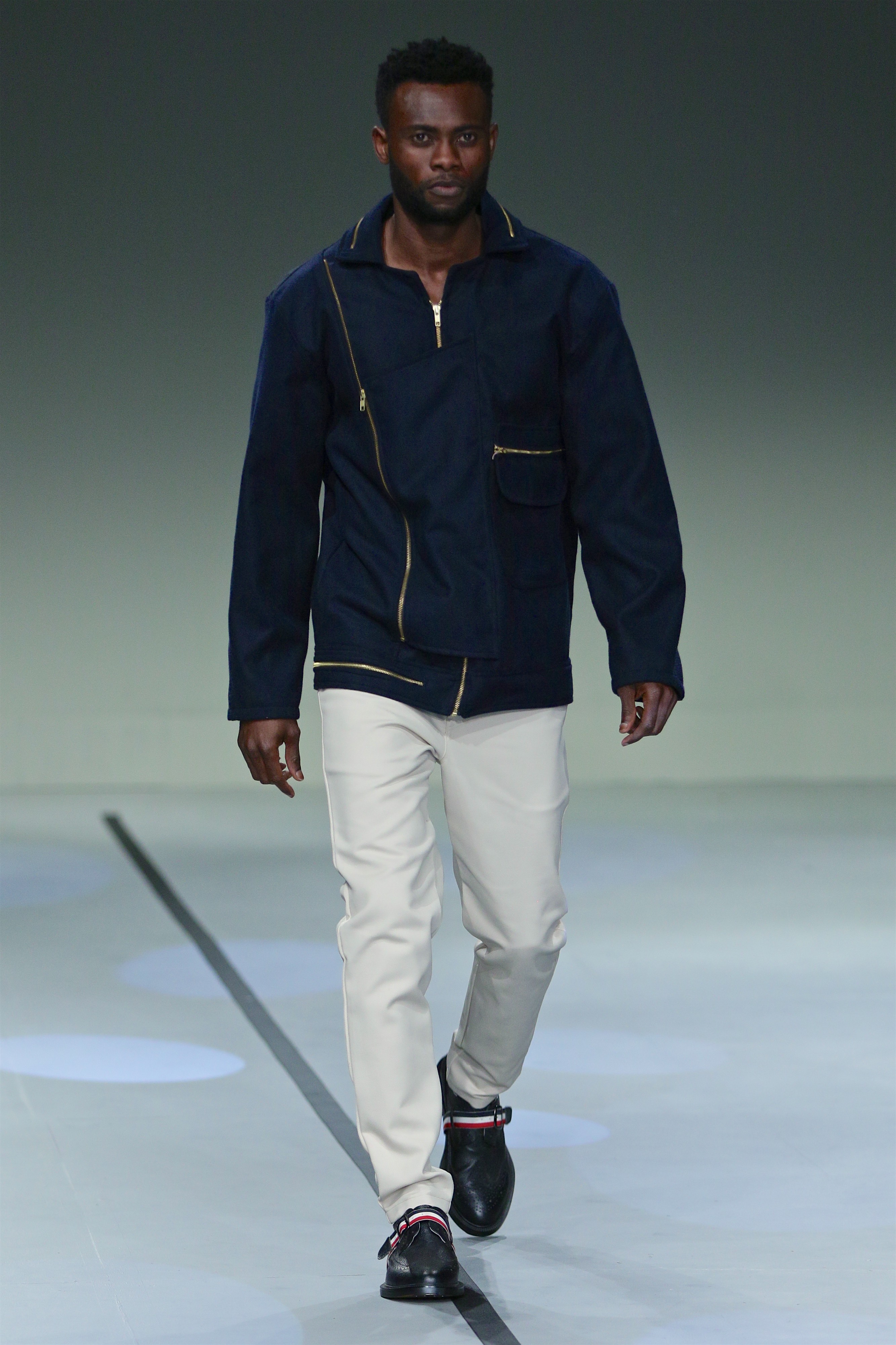 SA Fashion Week runway look in navy jacket and white trousers