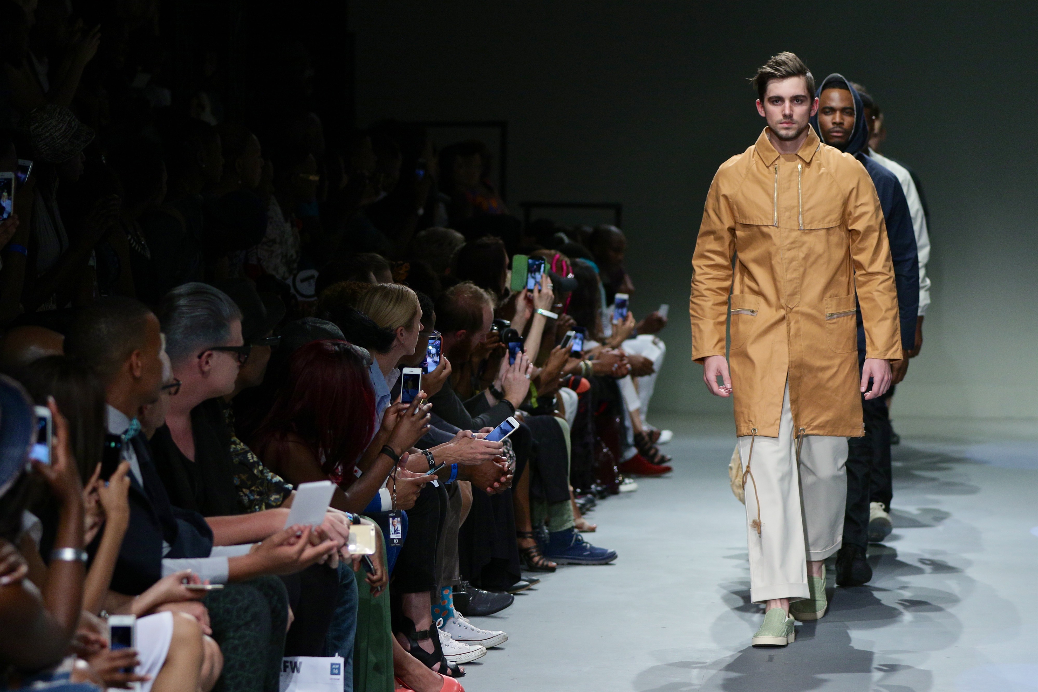 SA Fashion Week runway lineup with ochre coat look